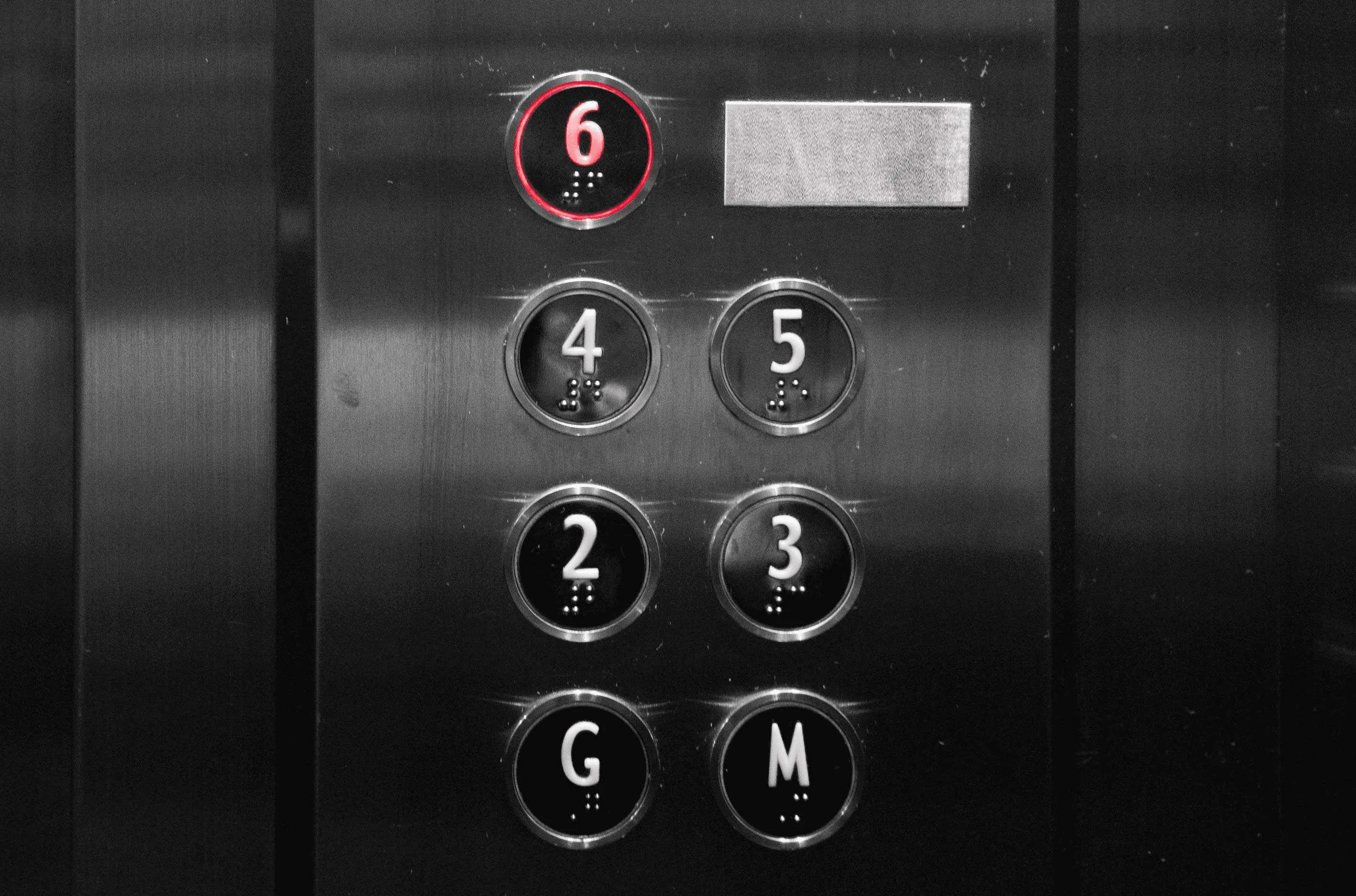 braille on elevator buttons below numbers so that blind people can use it easily